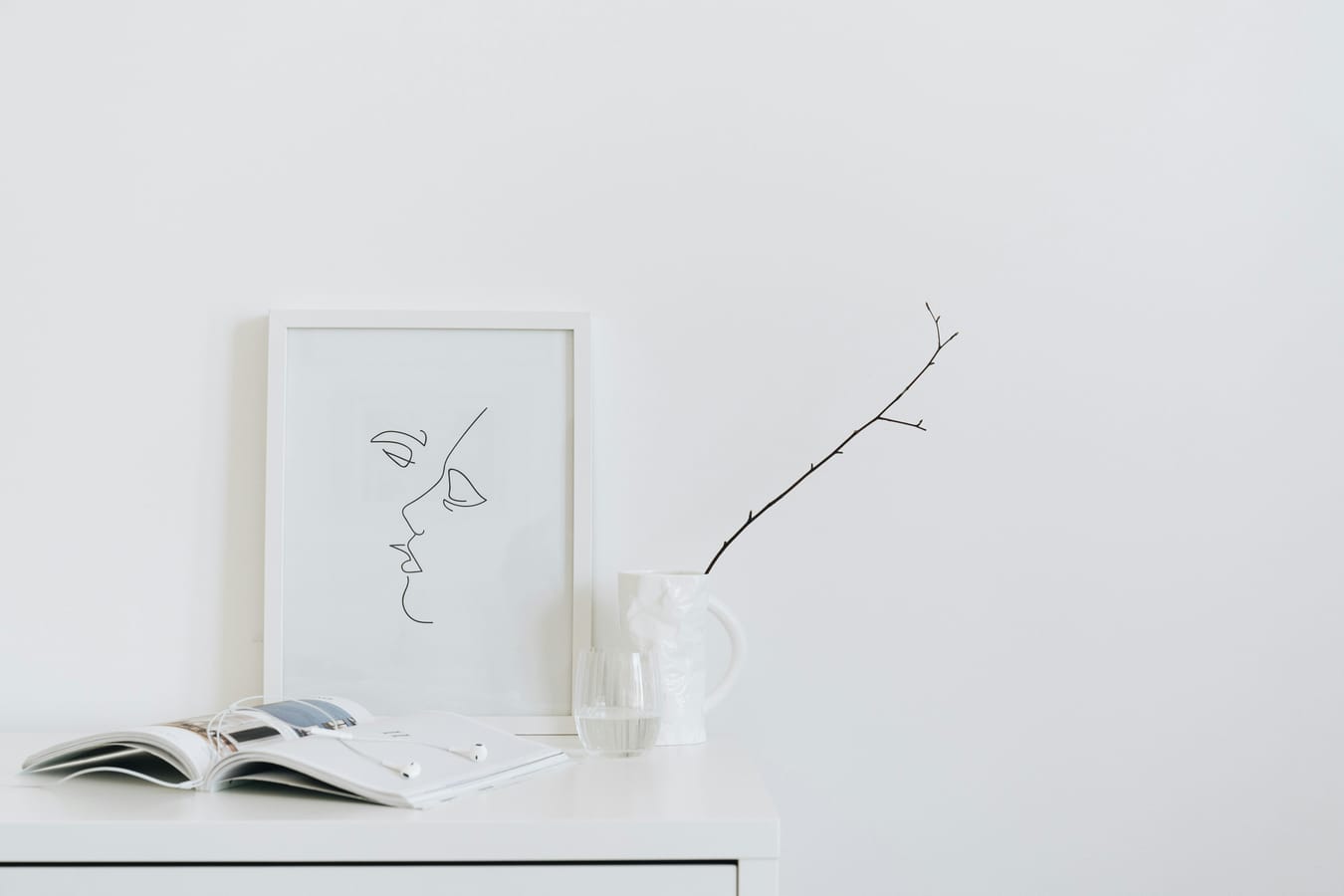 A line drawing of a human brain on paper beside a glass of water in soft natural light.