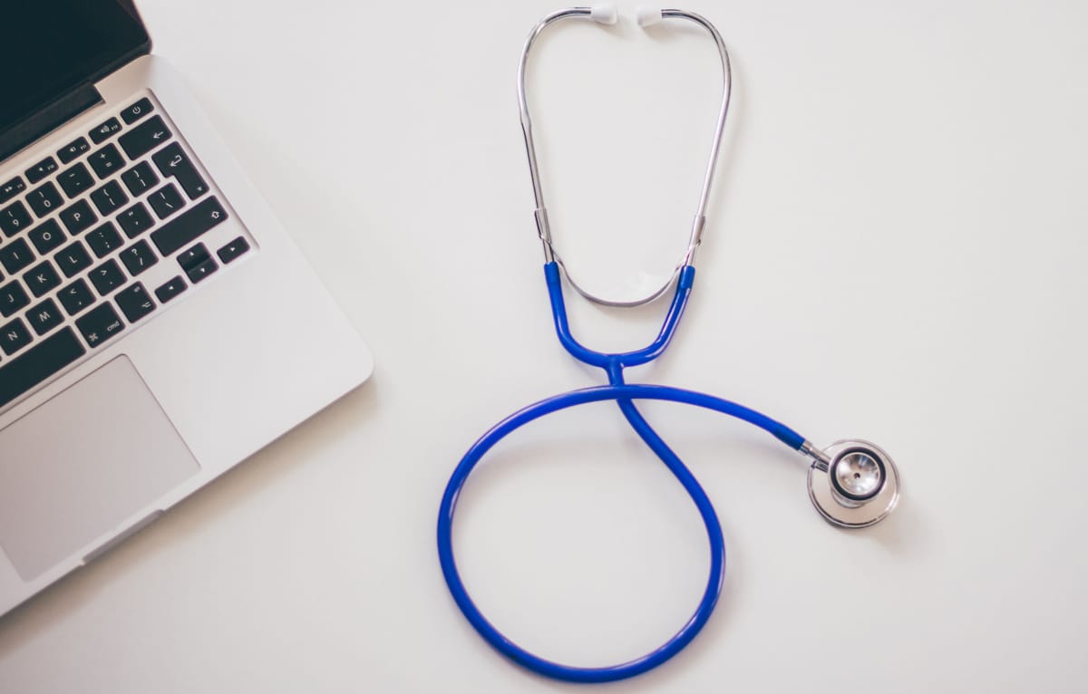 A stethoscope on a desk in soft natural light.
