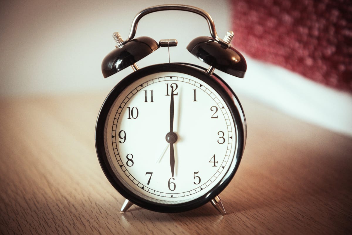 A clock on a bedside table.