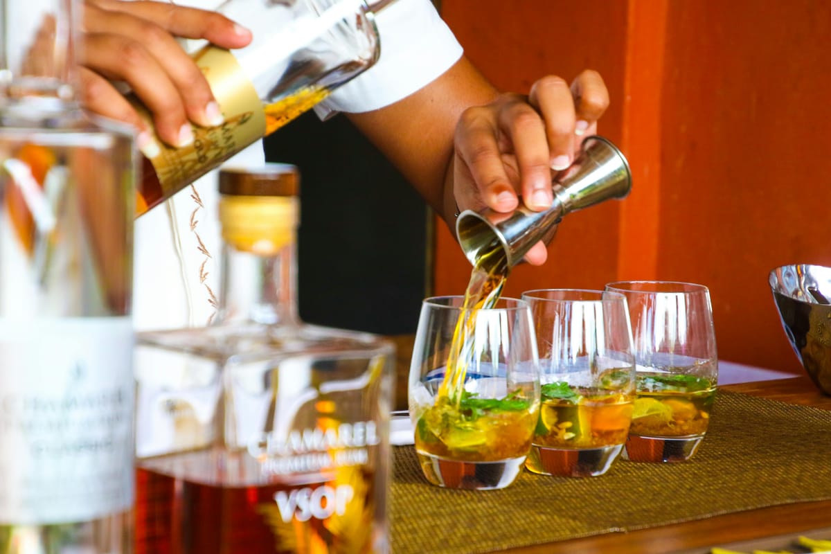 A spirit being poured into a shot glass.