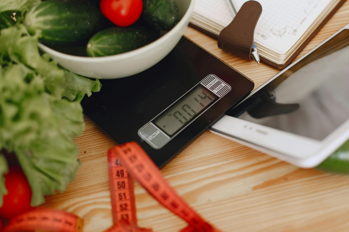 A kitchen scale on a wooden surface.