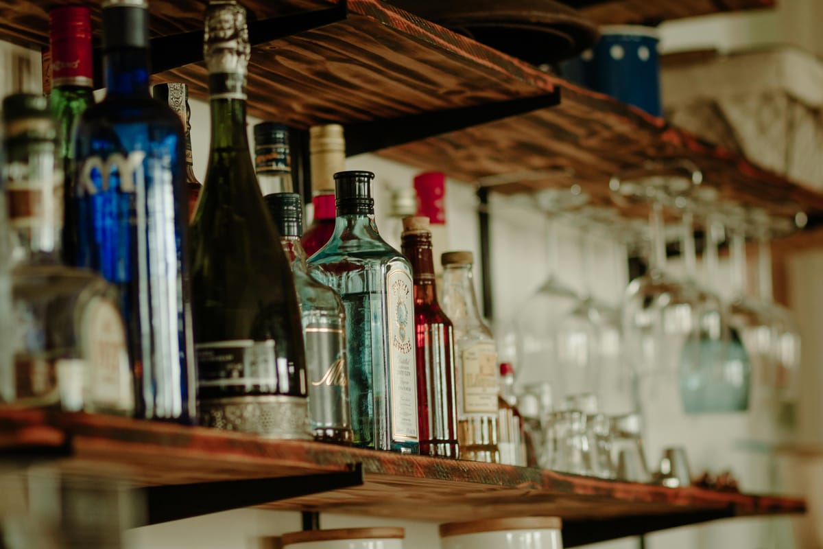Different drinks lined up on a wooden bar for comparison.