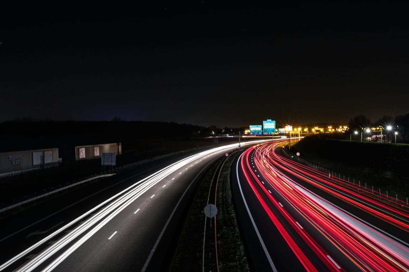 Long-exposure light trails on a highway at night, a visual metaphor for a multi-day App Review cycle and the patience the process demands.