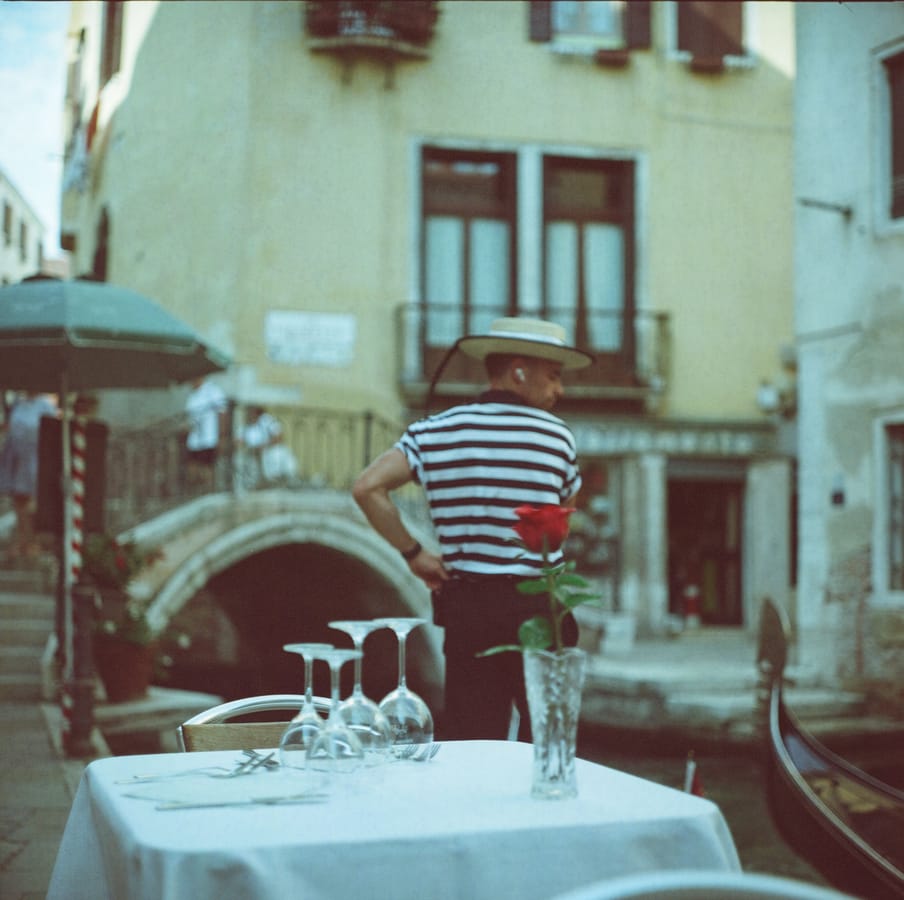 A glass of water and a glass of wine side by side on a table.