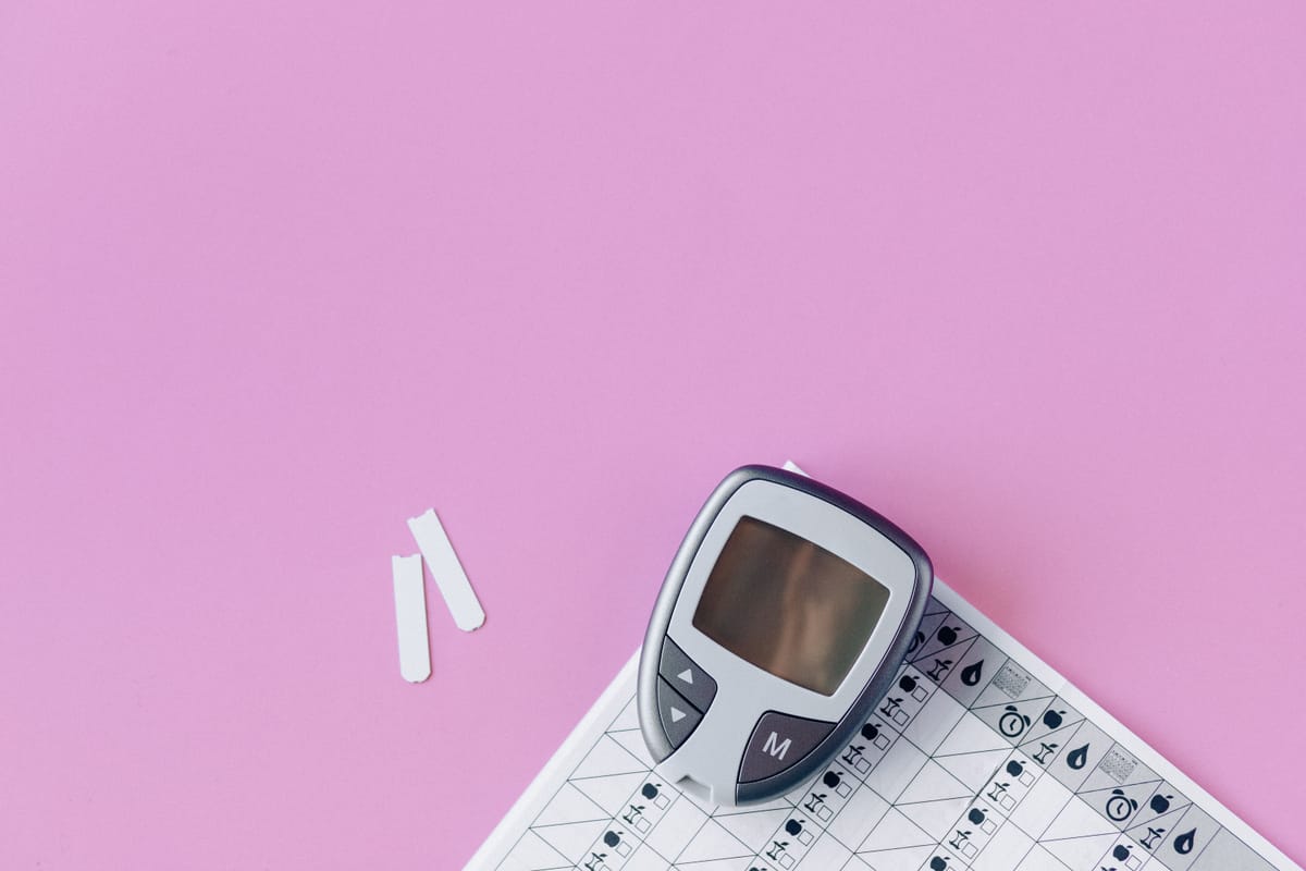 A blood glucose meter resting on a table.