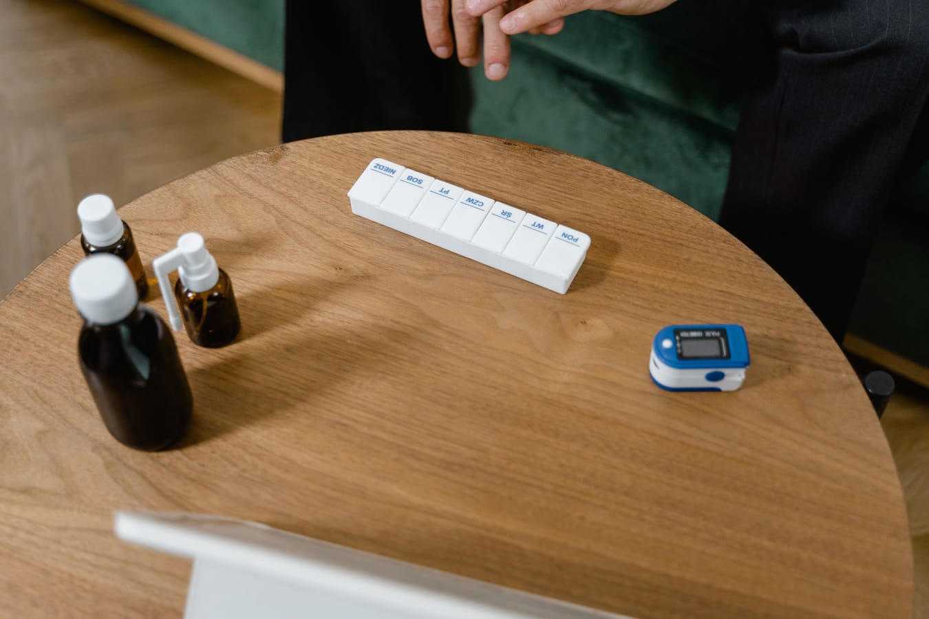 Two medication containers side by side on a wooden surface.