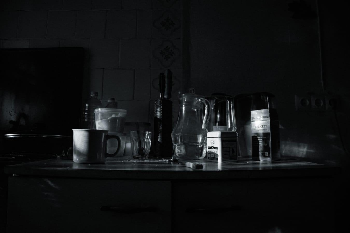 An assortment of electrolyte drink sachets and bottles arranged neatly on a kitchen counter in morning light.