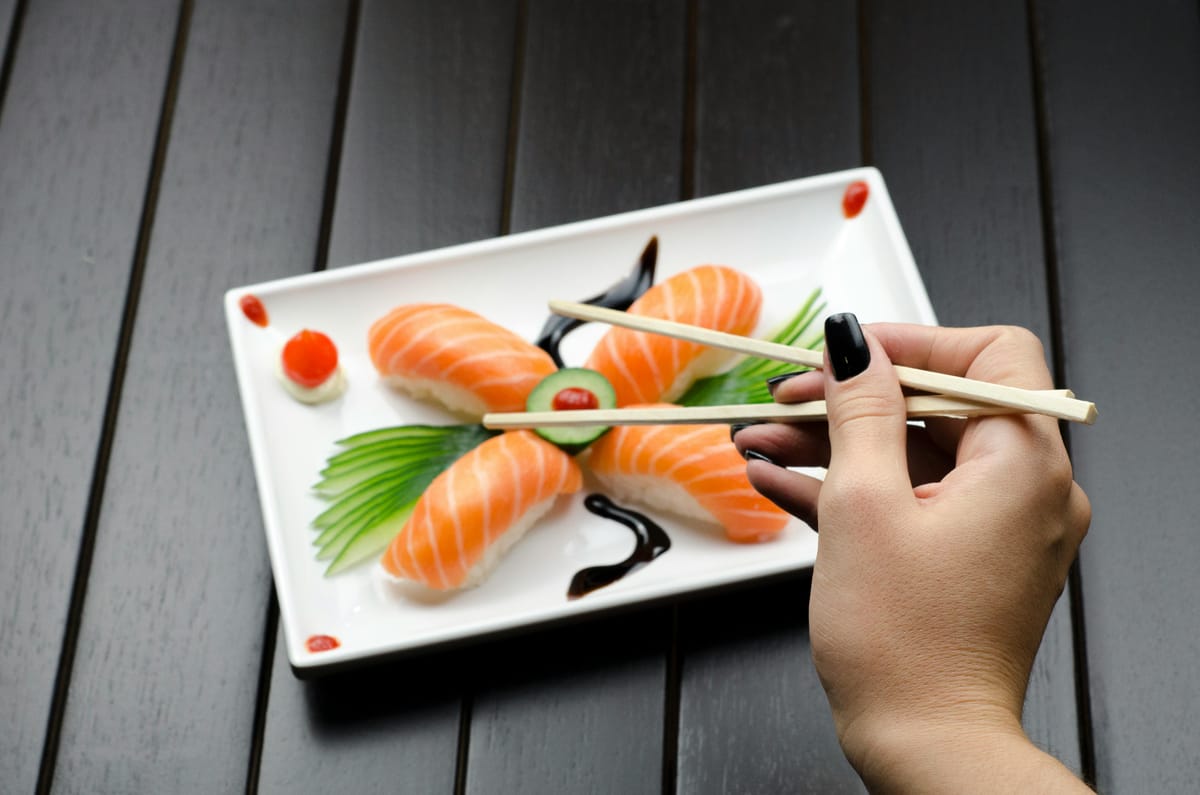 A meal of salmon and rice on a wooden table.