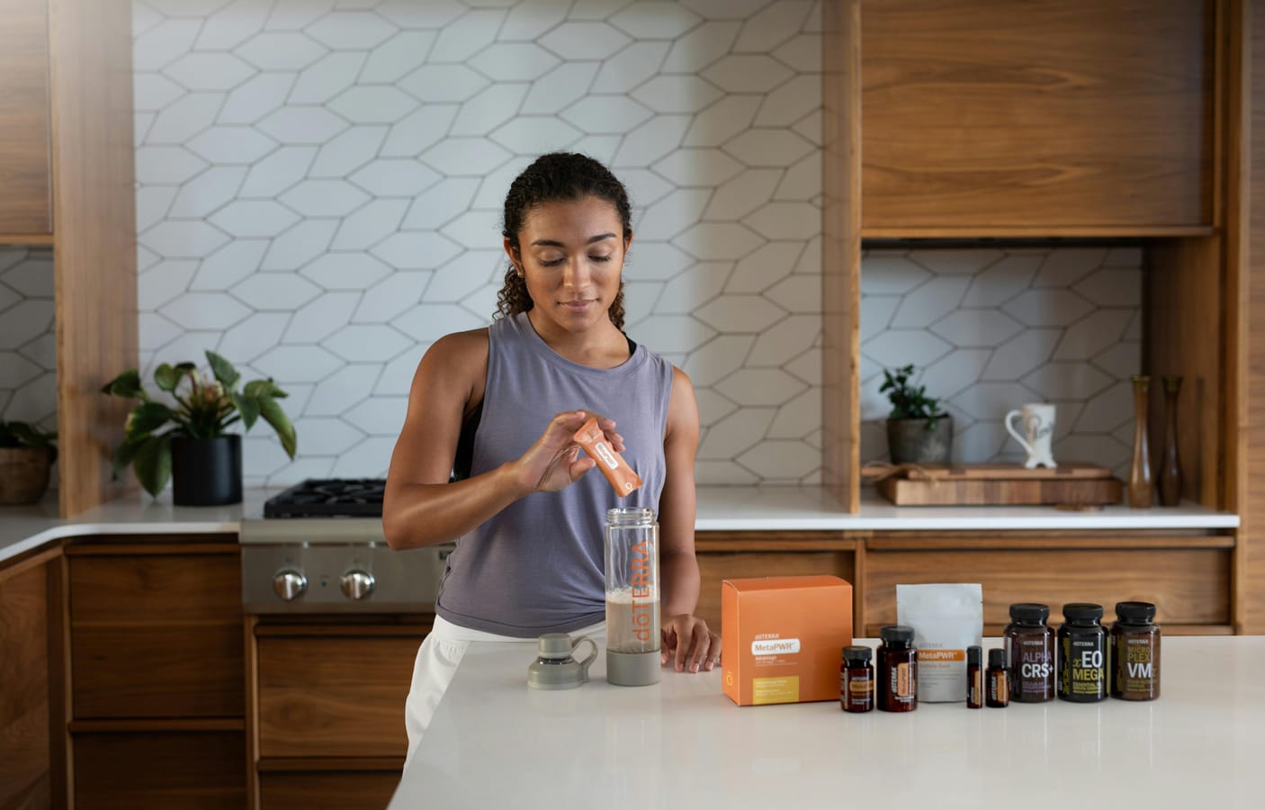 A cluttered kitchen counter with various supplement bottles and a glass of water in morning light.
