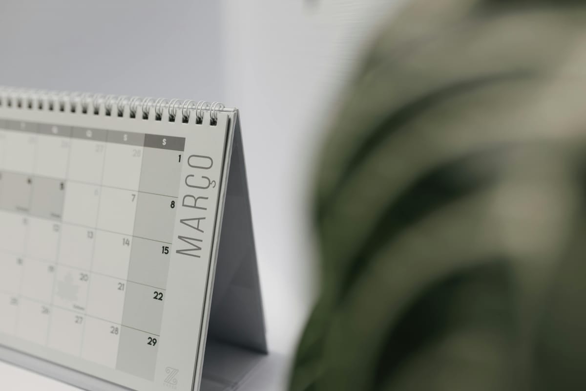 A monthly calendar on a wooden surface.