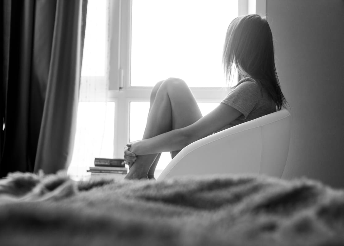 A person seated quietly with eyes closed.