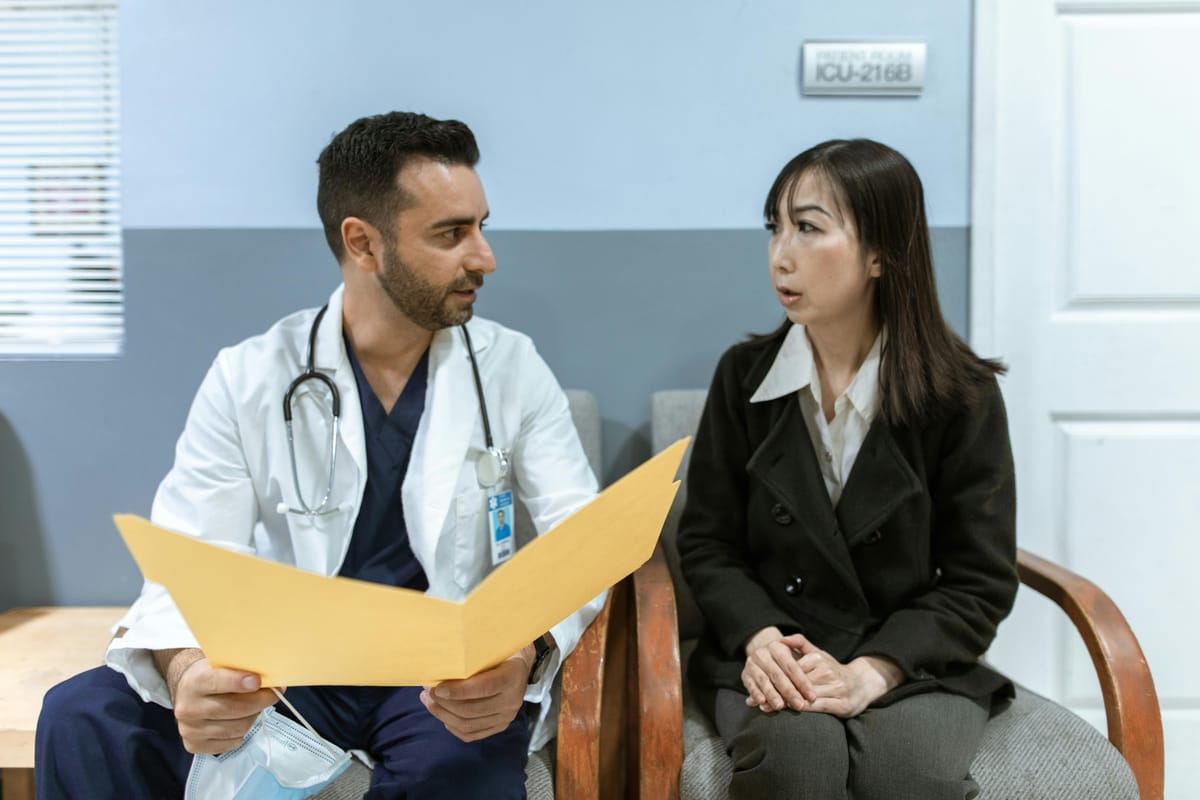 A doctor and patient in conversation, focused on listening, warm natural light.