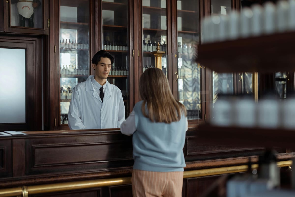 A pharmacy interior with shelves of medication bottles.
