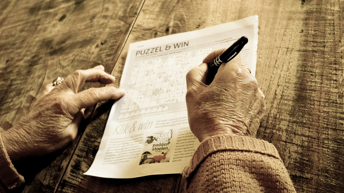 A worksheet and pen on a wooden desk.